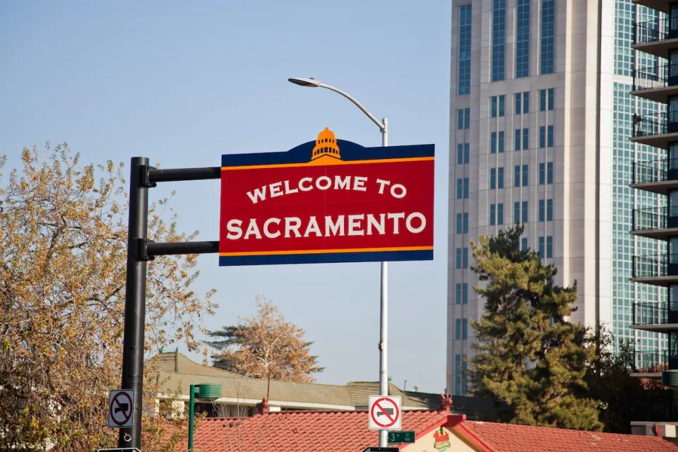 Red 'Welcome to Sacramento' sign in downtown Sacramento, California.